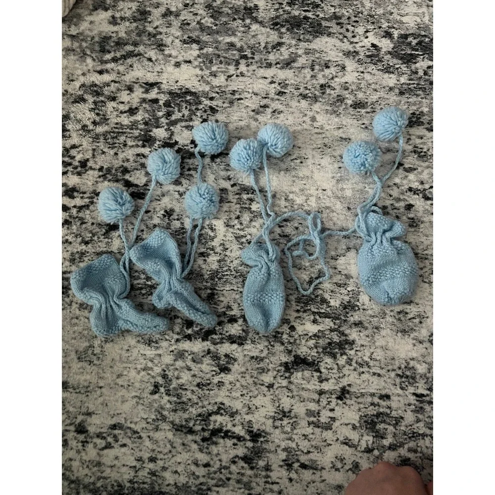 Knitted blue baby mittens and booties